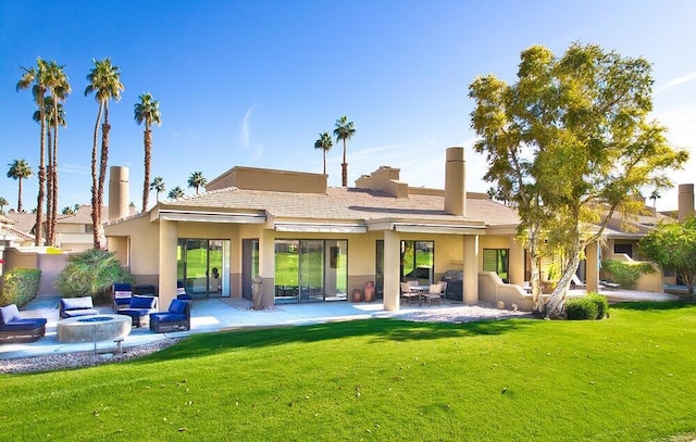 rear view of property featuring a lawn, a patio area, and an outdoor living space