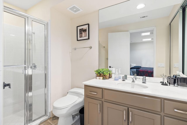 bathroom with vanity, toilet, and an enclosed shower