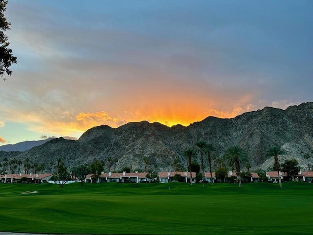 view of property's community featuring a mountain view and a lawn