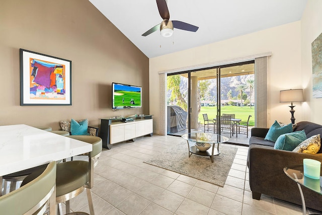 tiled living room with high vaulted ceiling and ceiling fan