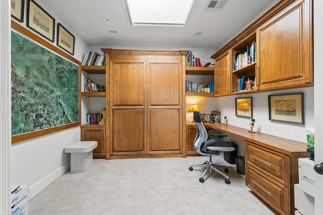 office area featuring light carpet and built in desk