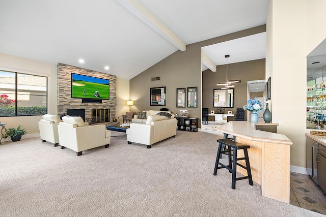 carpeted living room featuring ceiling fan, beam ceiling, a fireplace, and high vaulted ceiling