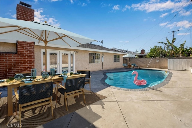 view of swimming pool with a patio area and french doors