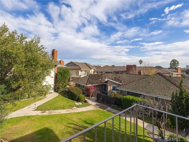 exterior space featuring a residential view and fence