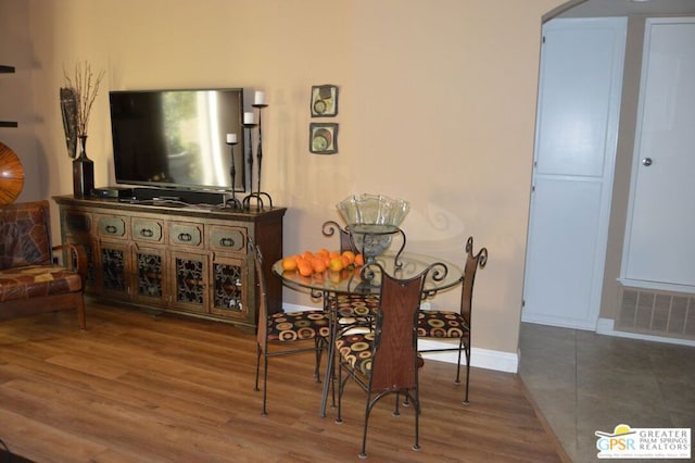 dining space with hardwood / wood-style floors