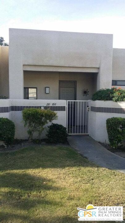 doorway to property with a lawn