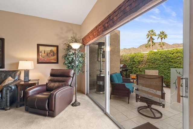 interior space with a mountain view, tile patterned flooring, and vaulted ceiling