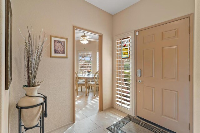 entryway with ceiling fan and light tile patterned floors