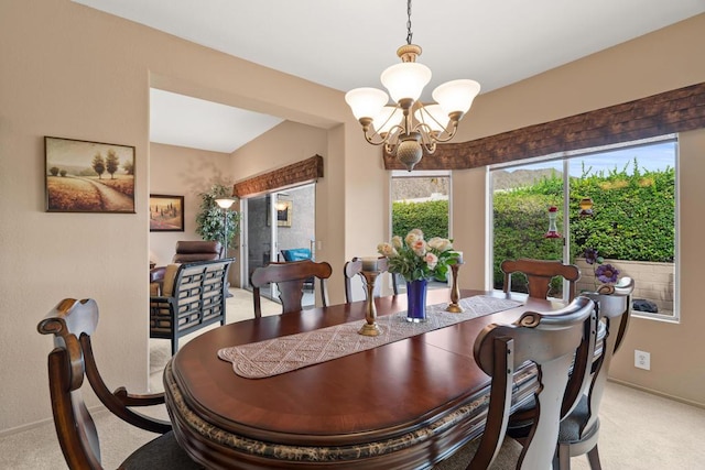 carpeted dining area with a notable chandelier