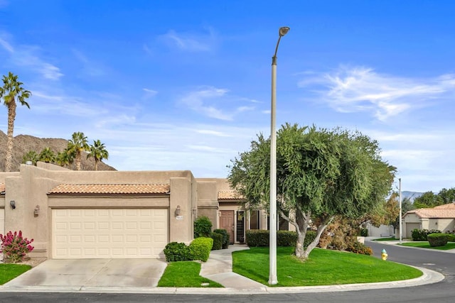 view of front of home with a front yard and a garage