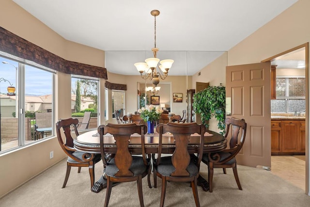 carpeted dining area with a notable chandelier