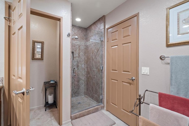 bathroom with tile patterned floors and walk in shower