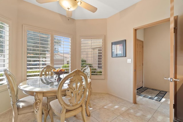 tiled dining room featuring ceiling fan