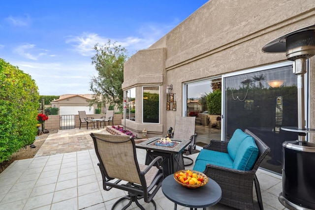 view of patio with an outdoor living space with a fire pit