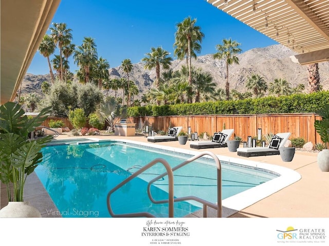 view of pool featuring a mountain view and a patio