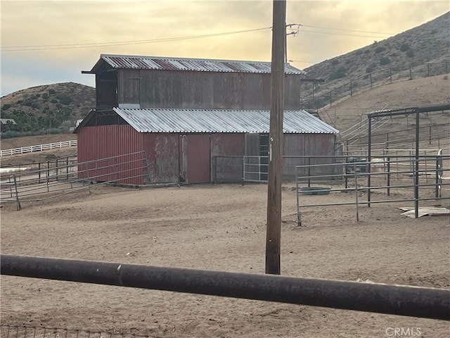 view of stable with a mountain view