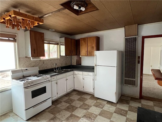 kitchen featuring decorative backsplash, white appliances, white cabinetry, and sink