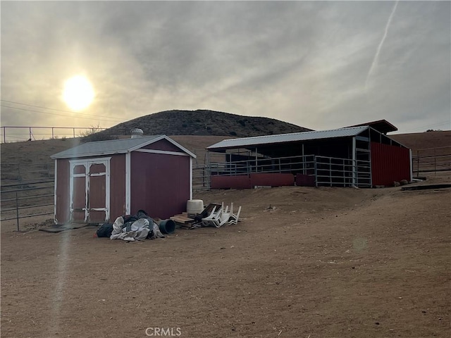 outdoor structure at dusk featuring a mountain view