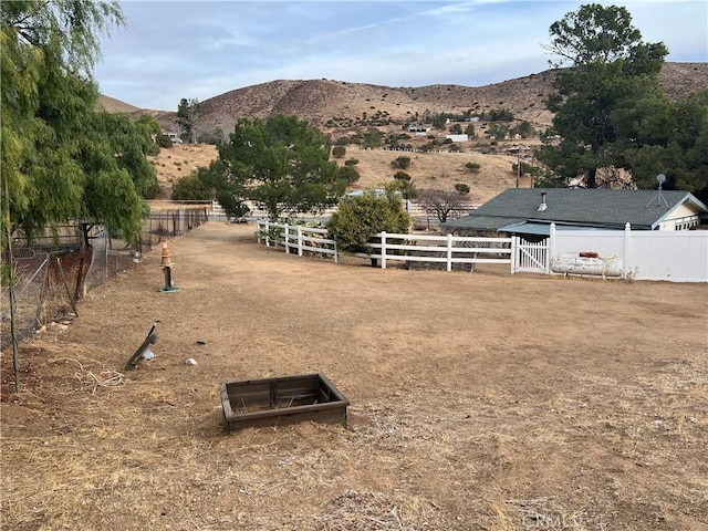 view of yard featuring a mountain view and a rural view