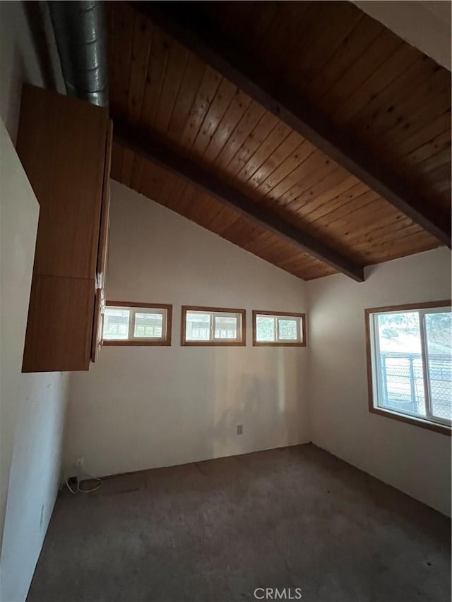 spare room with carpet, vaulted ceiling with beams, and wooden ceiling