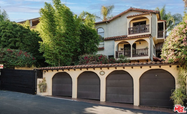 mediterranean / spanish-style home featuring a balcony