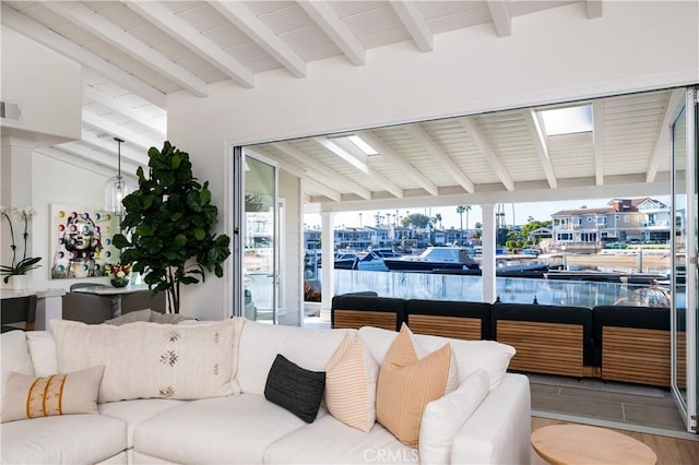 living room with lofted ceiling with beams