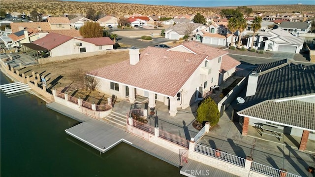 drone / aerial view with a residential view and a water view