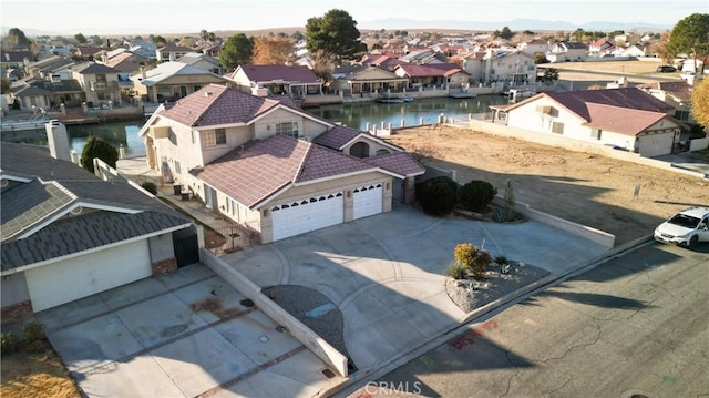 bird's eye view featuring a residential view and a water view