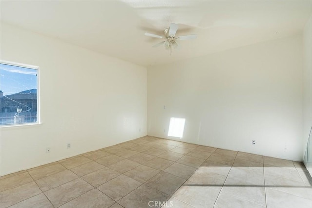 empty room featuring light tile patterned floors and ceiling fan