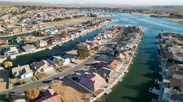 drone / aerial view with a residential view and a water view