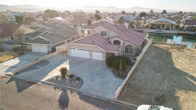 drone / aerial view featuring a residential view and a water view