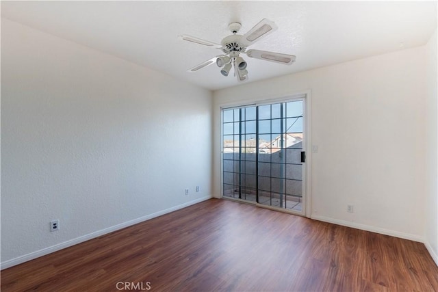 unfurnished room with baseboards, ceiling fan, and wood finished floors