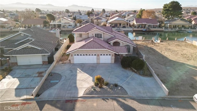 drone / aerial view featuring a residential view and a water view