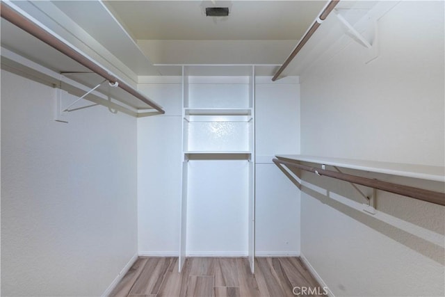 walk in closet featuring light wood finished floors