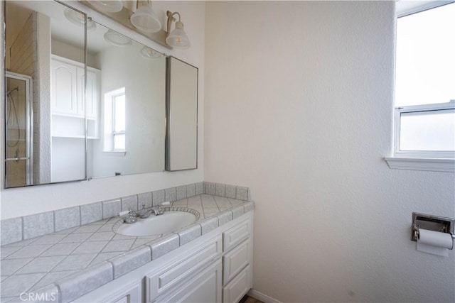 bathroom with plenty of natural light and vanity