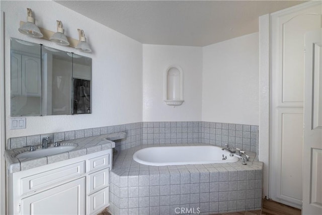 bathroom with a bath and vanity