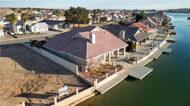 birds eye view of property with a residential view and a water view