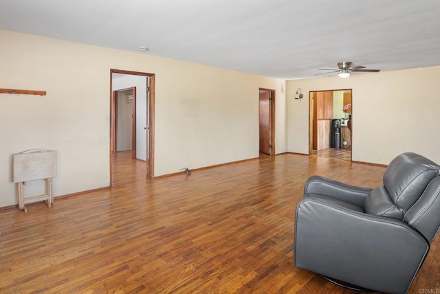 living room featuring ceiling fan and wood-type flooring