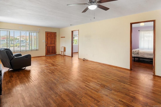 living room featuring ceiling fan, a healthy amount of sunlight, and hardwood / wood-style floors