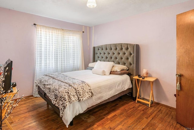 bedroom with hardwood / wood-style flooring