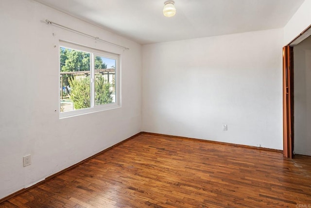 spare room featuring dark hardwood / wood-style flooring