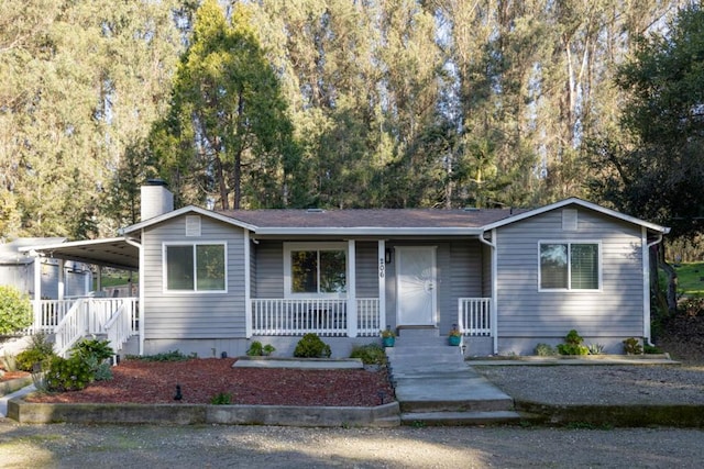 view of front of home with a carport and a porch