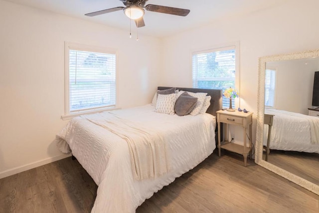 bedroom with wood-type flooring and ceiling fan