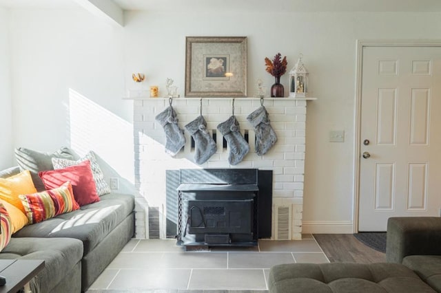 tiled living room with a wood stove