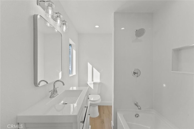 full bathroom featuring vanity, toilet, wood-type flooring, and bathtub / shower combination