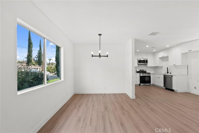 interior space featuring light hardwood / wood-style floors and a notable chandelier