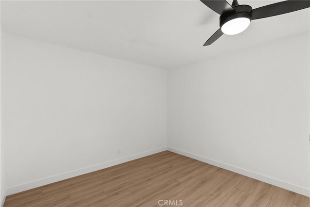 spare room with ceiling fan and light wood-type flooring