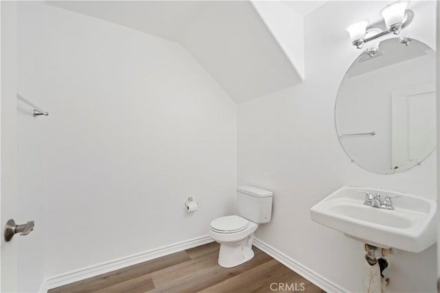 bathroom with hardwood / wood-style flooring and toilet