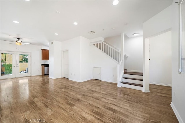 unfurnished living room with ceiling fan, wood-type flooring, and french doors