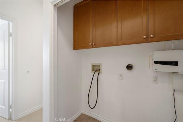 laundry room featuring cabinets, hookup for a washing machine, and water heater